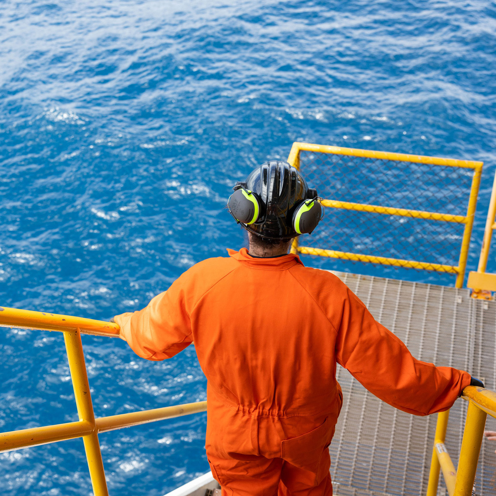 worker walking down steps on offshore platform